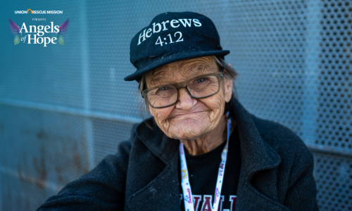 Photo of a woman with wrinkles on her face, wearing a black hat that says Hebrews 4:12